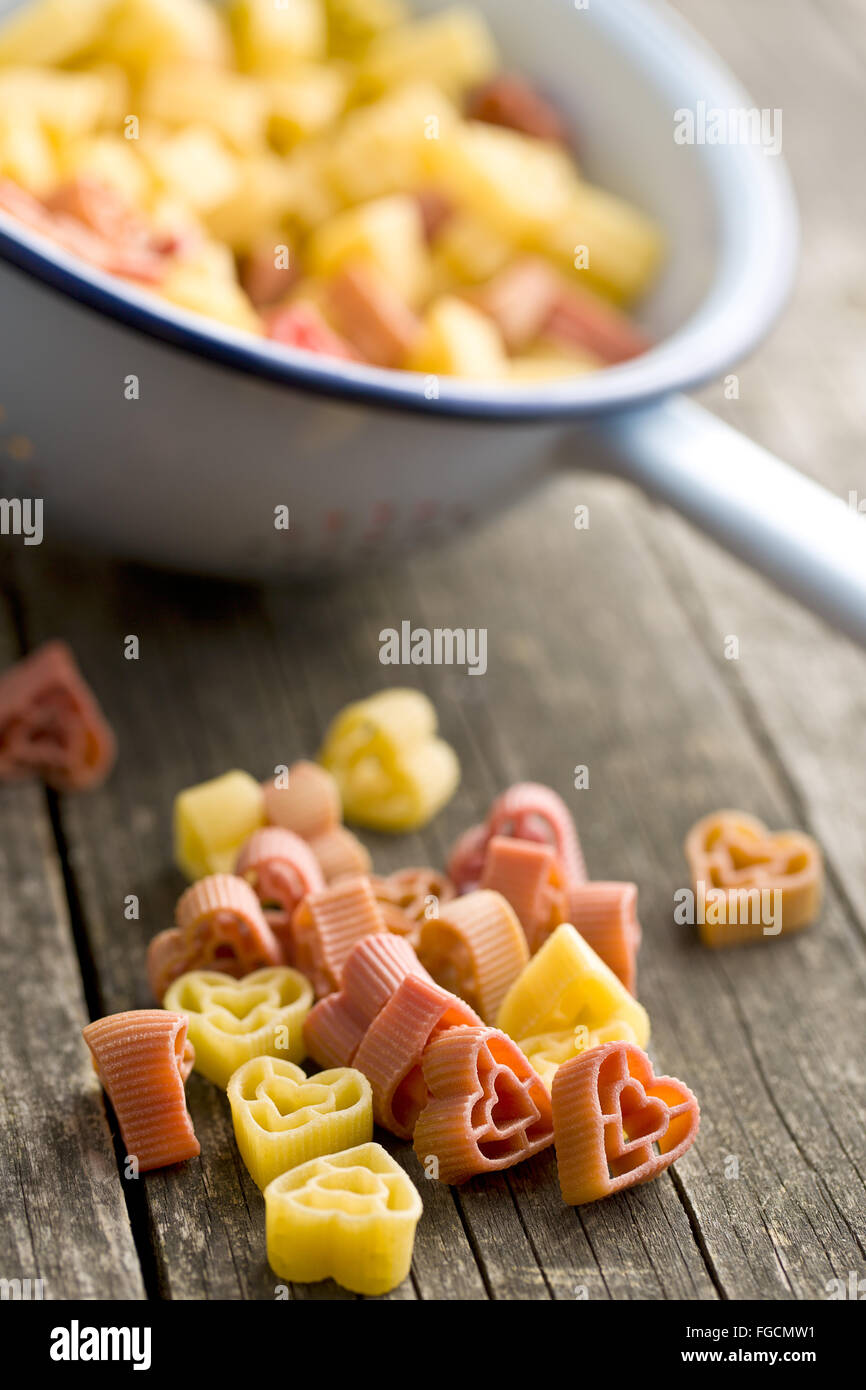 heart shaped pasta on old wooden table Stock Photo