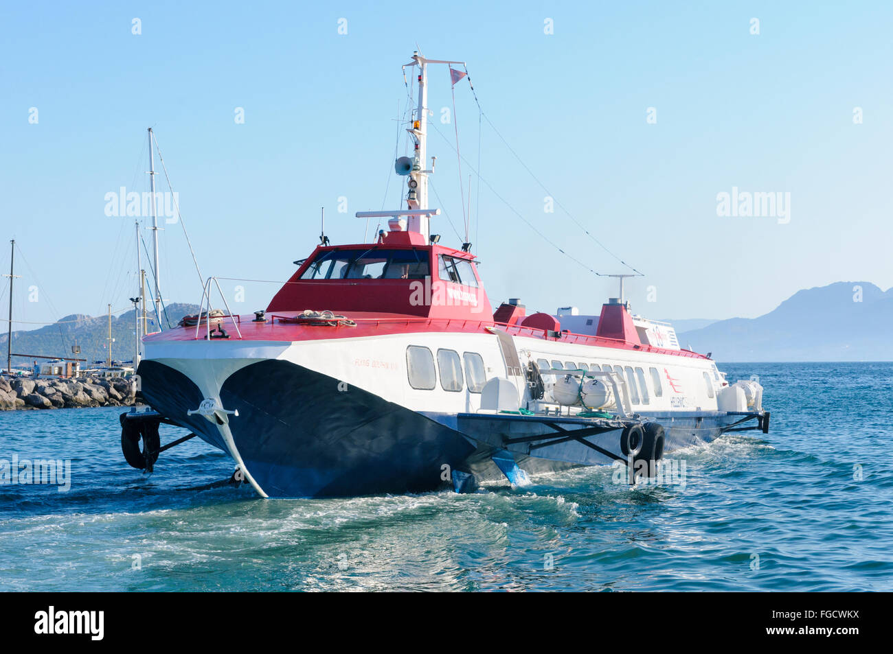 Hellenic Seaways Flying Dolphin Hydrofoil entering the port of Aegina, Saronic Islands, Greece Stock Photo