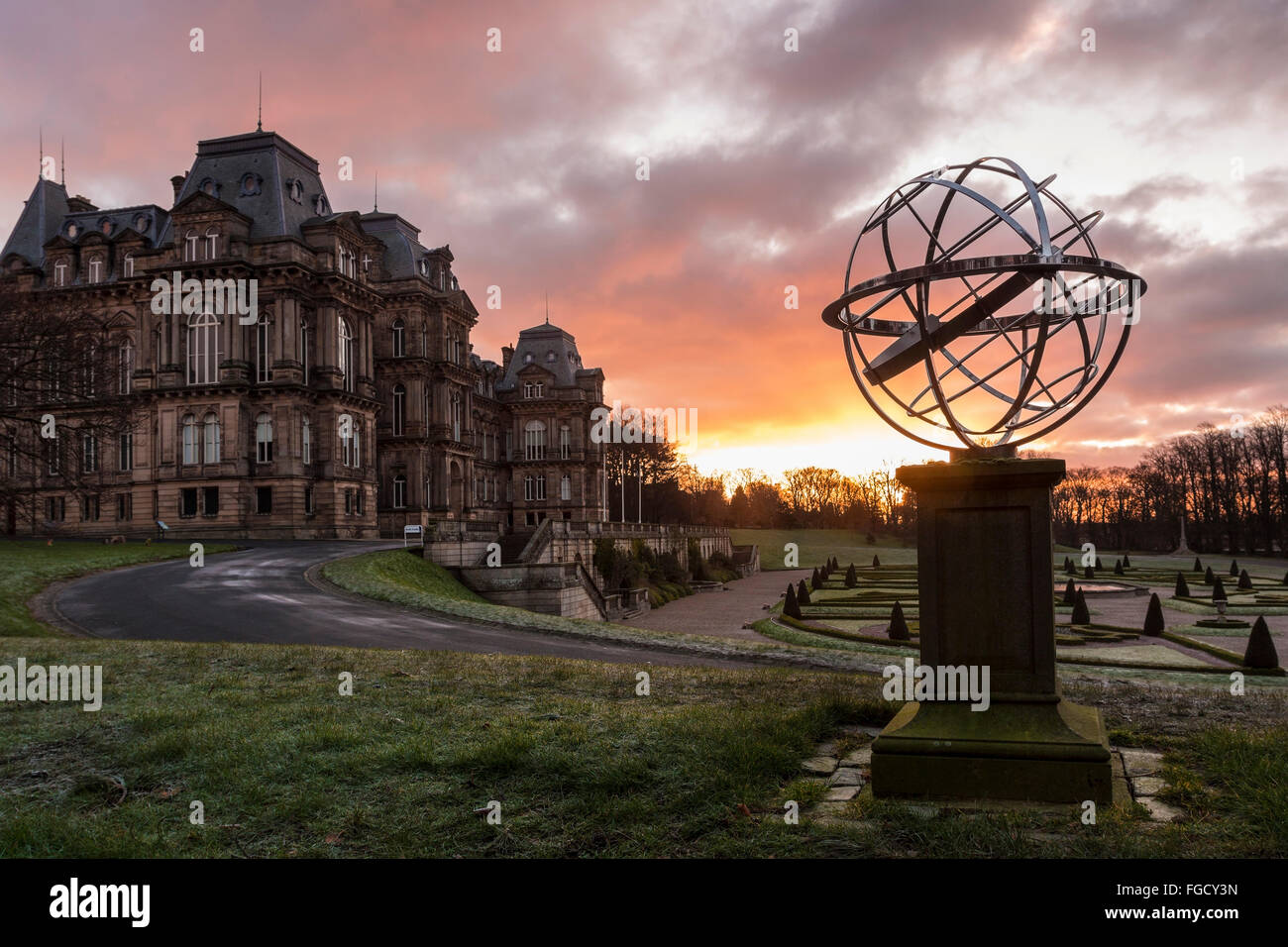 The Bowes Museum, Barnard Castle, Teesdale, County Durham, UK. 19th February 2016, UK Weather.  A colourful sunrise illuminating the Armillary Sphere Memorial to HM Queen Elizabeth The Queen Mother in the gardens of the Bowes Museum in Barnard Castle, where it was a cold and frosty start to the day Credit:  David Forster/Alamy Live News Stock Photo