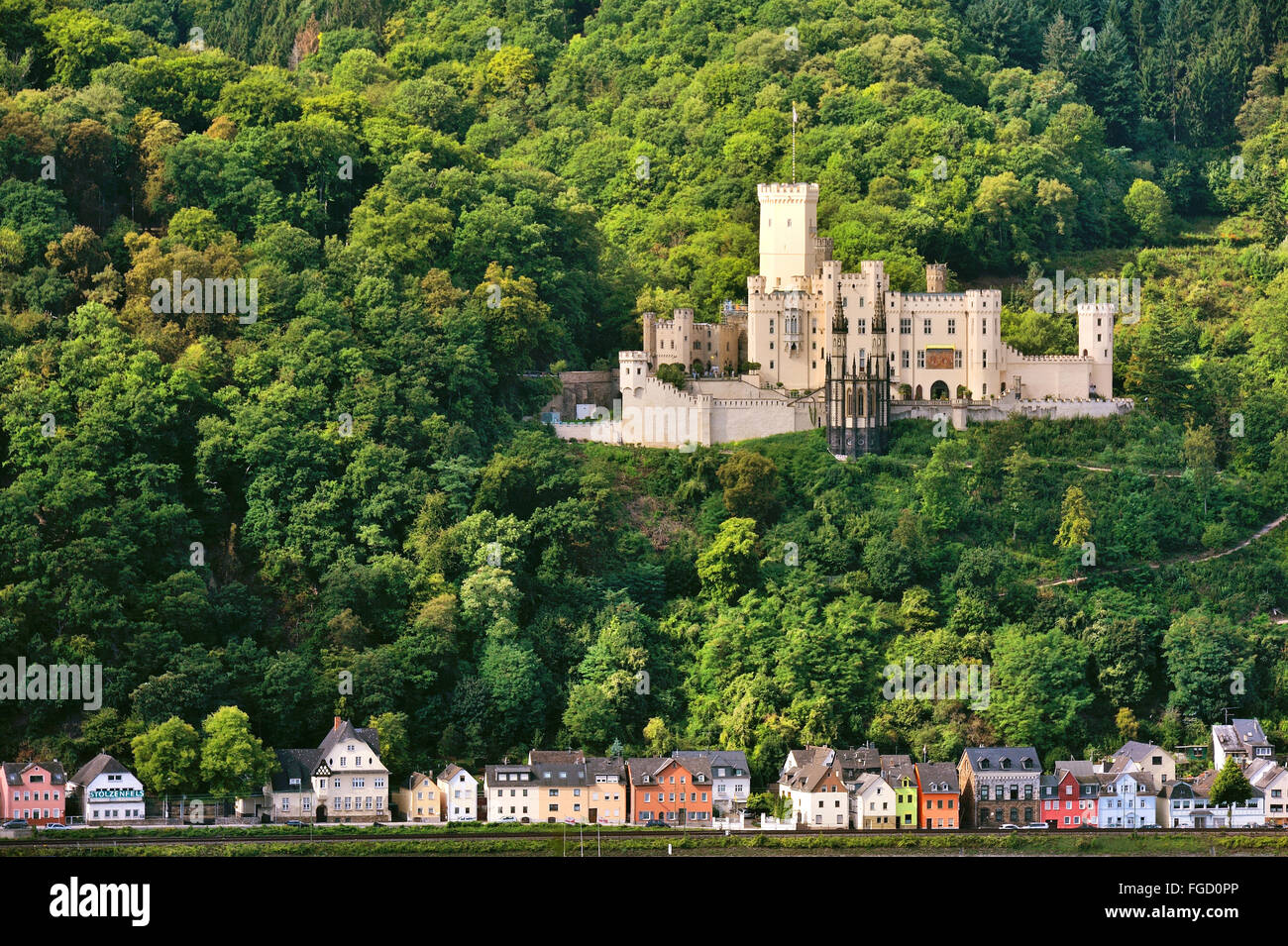 Stolzenfels Castle near Koblenz and lined colored houses at the river bank of the Rhine, Upper Middle Rhine Valley, Germany Stock Photo