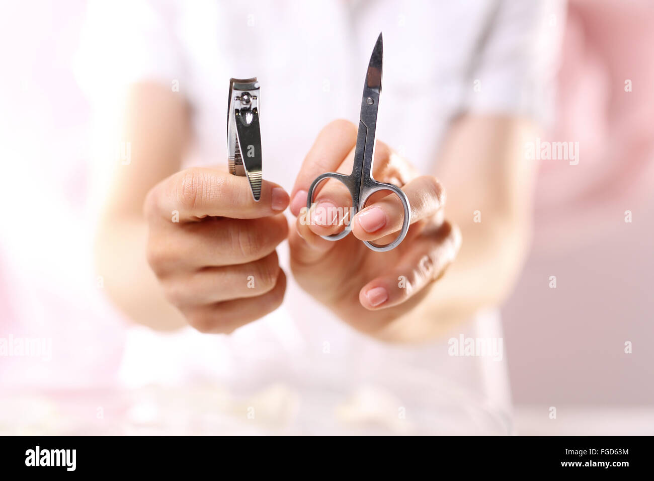 Manicure, nail clipping. Manicure tools. Clipper or scissors?. Clipping nails, hand care. Nail styling Stock Photo