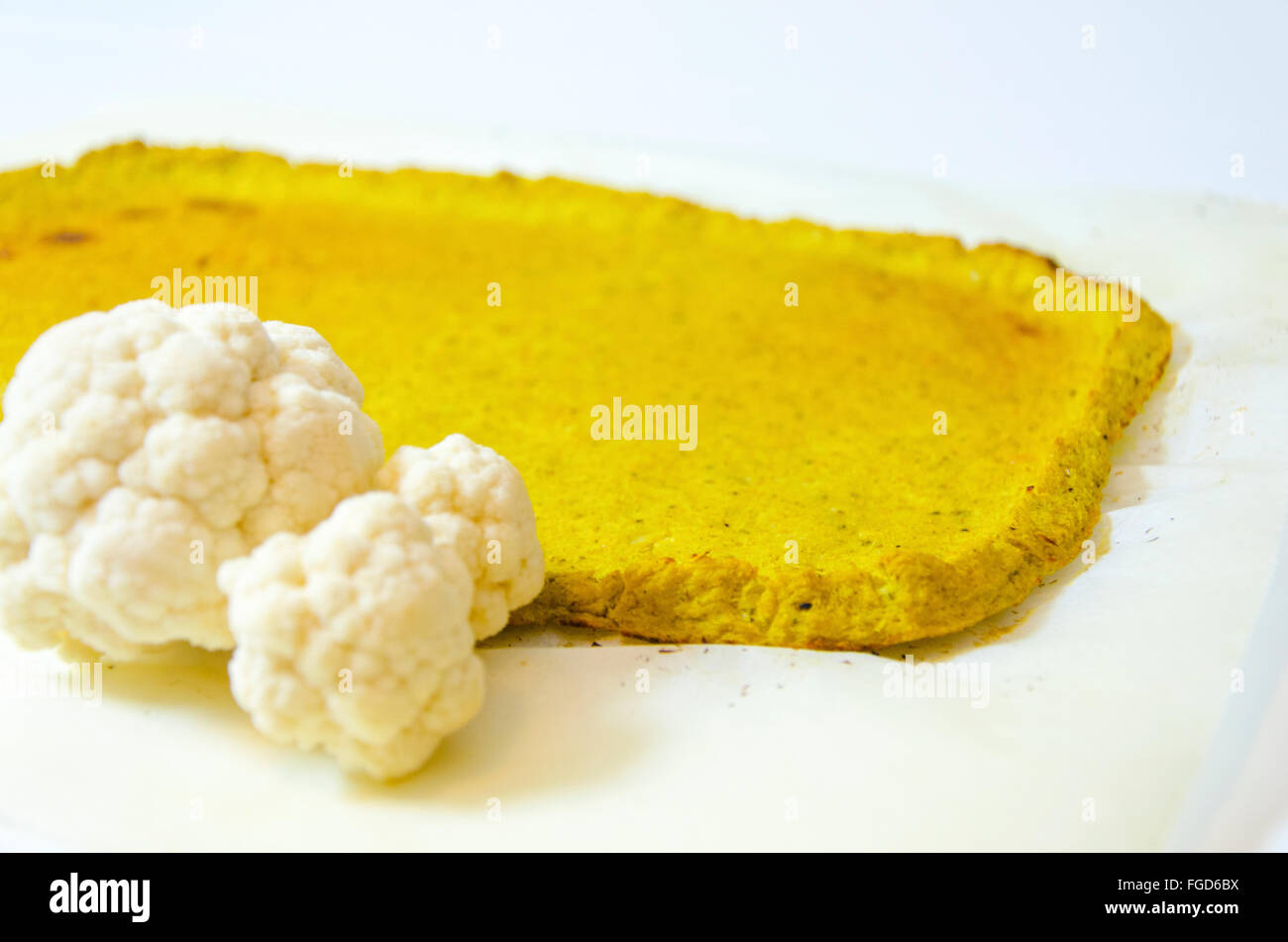 Rectangular cauliflower pizza crust with selective focus on edge. A healthy low carb, gluten free, vegan, vegetarian snack with Stock Photo