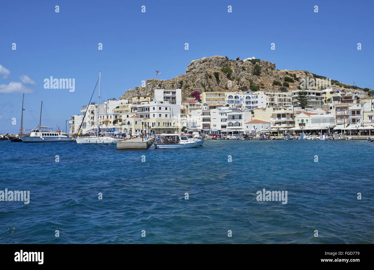 View of coastal town with boats in harbour, Pigadia, Karpathos