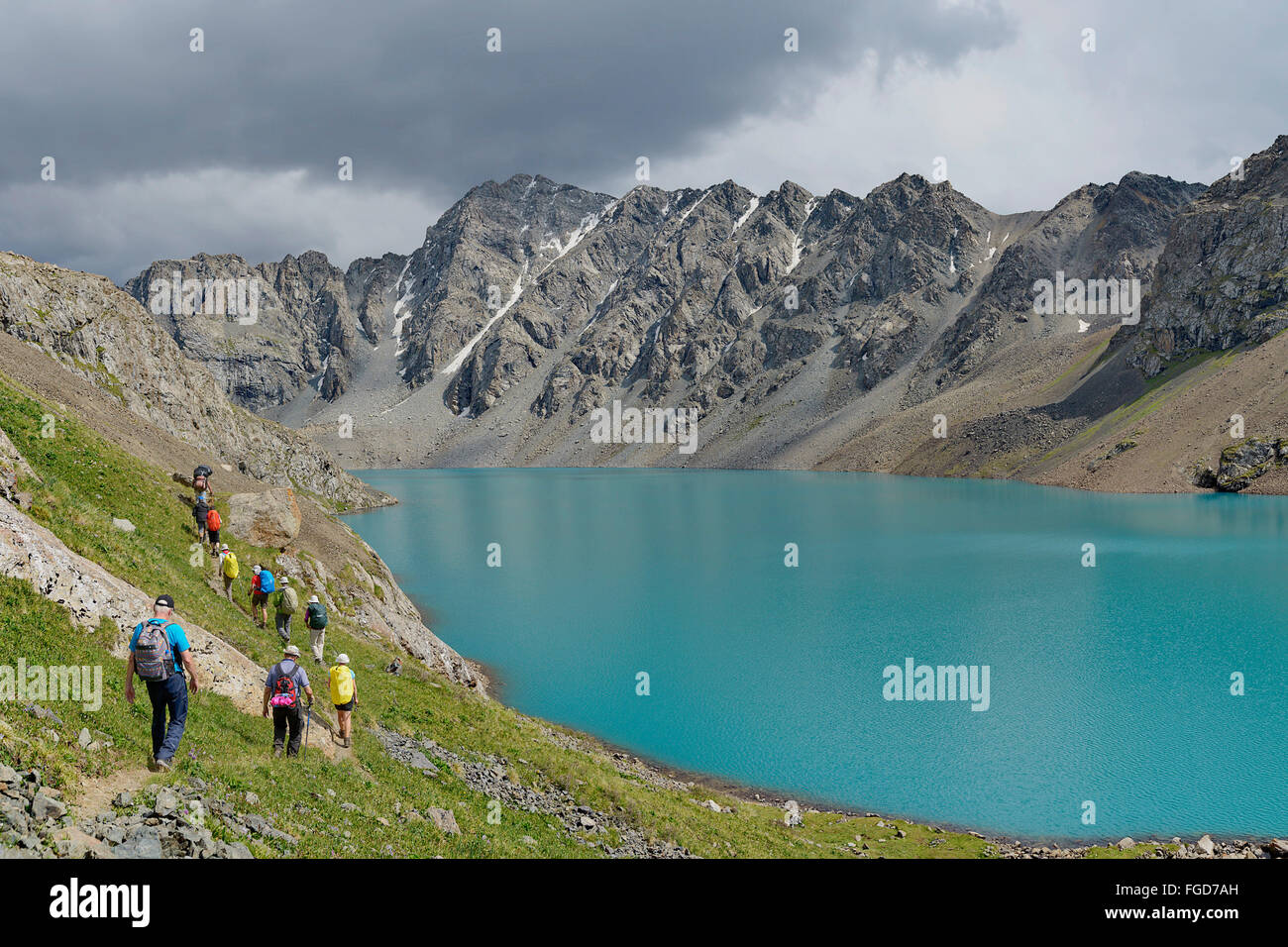 Trekking group at Ala-Kol Lake, Kyrgyzstan. Stock Photo