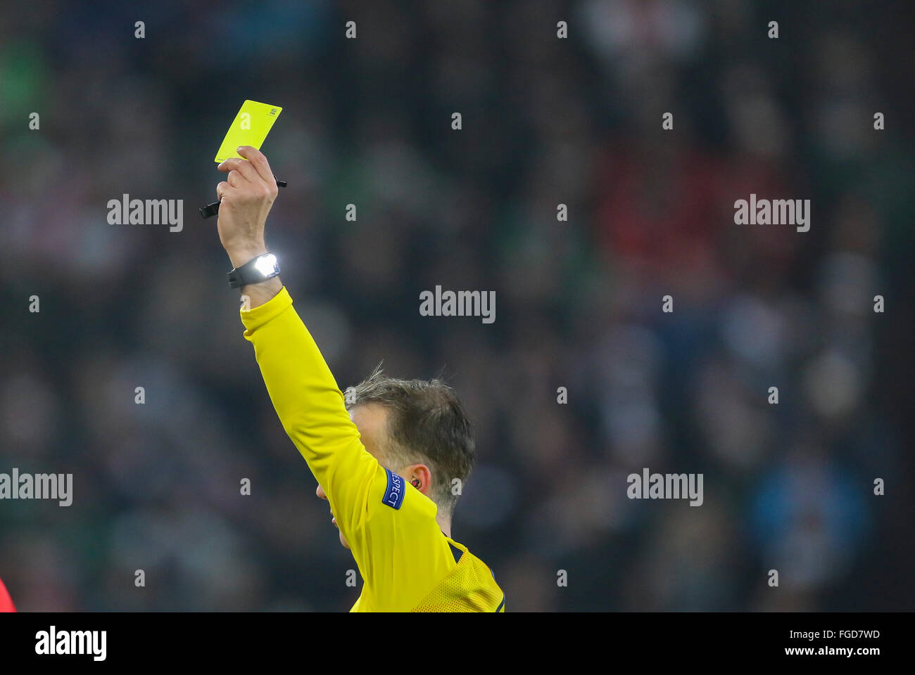 Augsburg, Germany. 18th February, 2016. Chief Judge David Fernández Borbalán, ESP, referee, linesman with flag, whistle icon image, illustration, showing a yellow card, a warning watch polar pulse  during the UEFA Europa League Round of 32: First Leg match FC Augsburg - Liverpool 0-0 on February 18, 2016 in Augsburg, Germany. Credit:  Peter Schatz / Alamy Live News Stock Photo