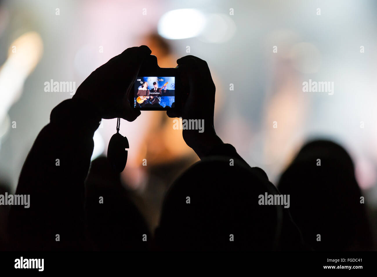 Concertgoers takes a photo with iPhone Stock Photo