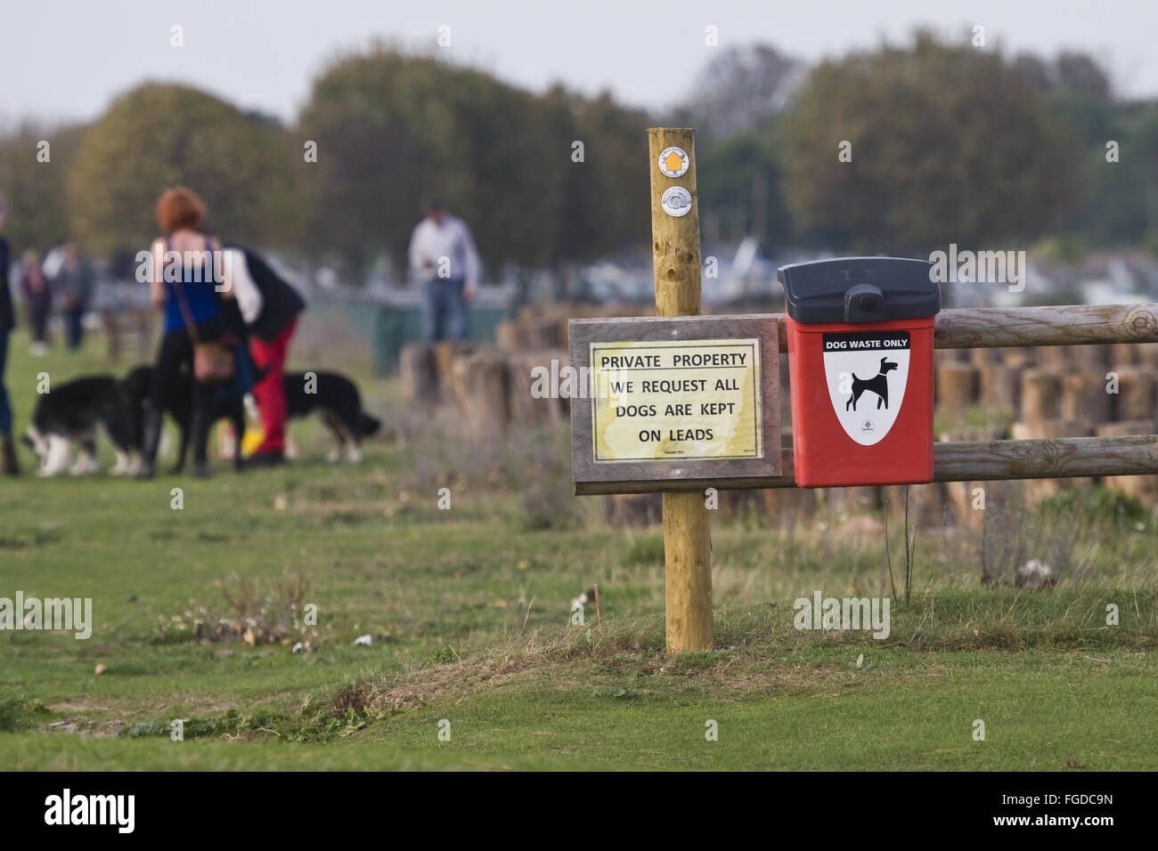 'Private Property', We Request All Dogs Are Kept On Leads' and 'Public Footpath' sign beside dog waste bin, Dunster Beach, near Stock Photo
