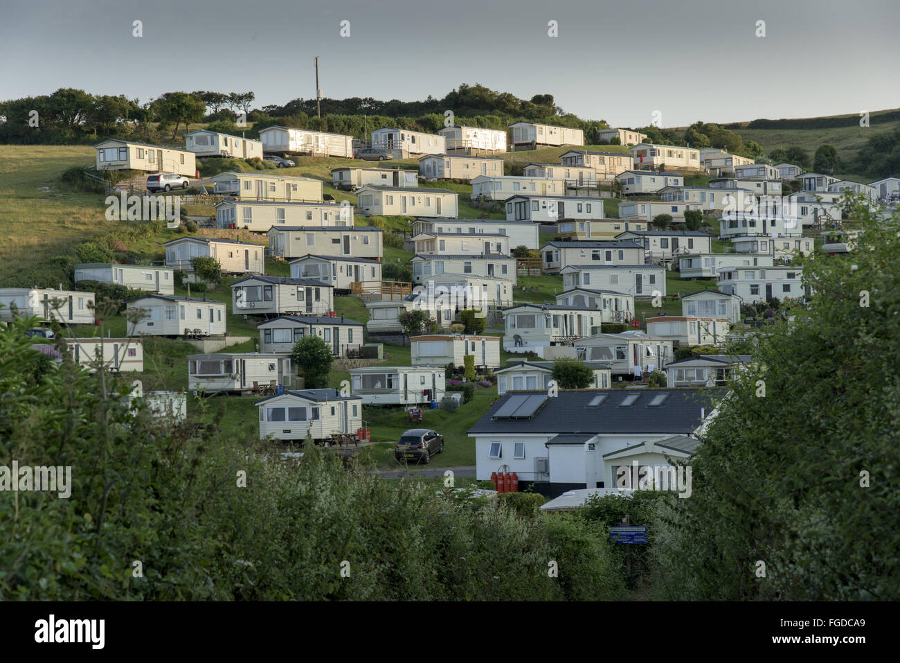 Caravans on coastal holiday park in evening sunlight, Beer, Lyme Bay, Devon, England, June Stock Photo