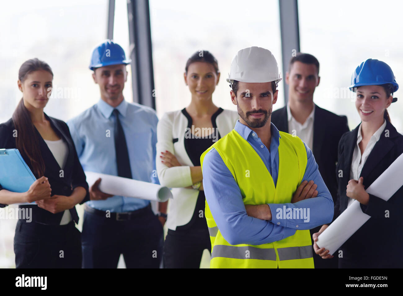 Человек в каске. Инженер архитектор. Строители смотрят чертеж. Builder laughing]. Looks builder.