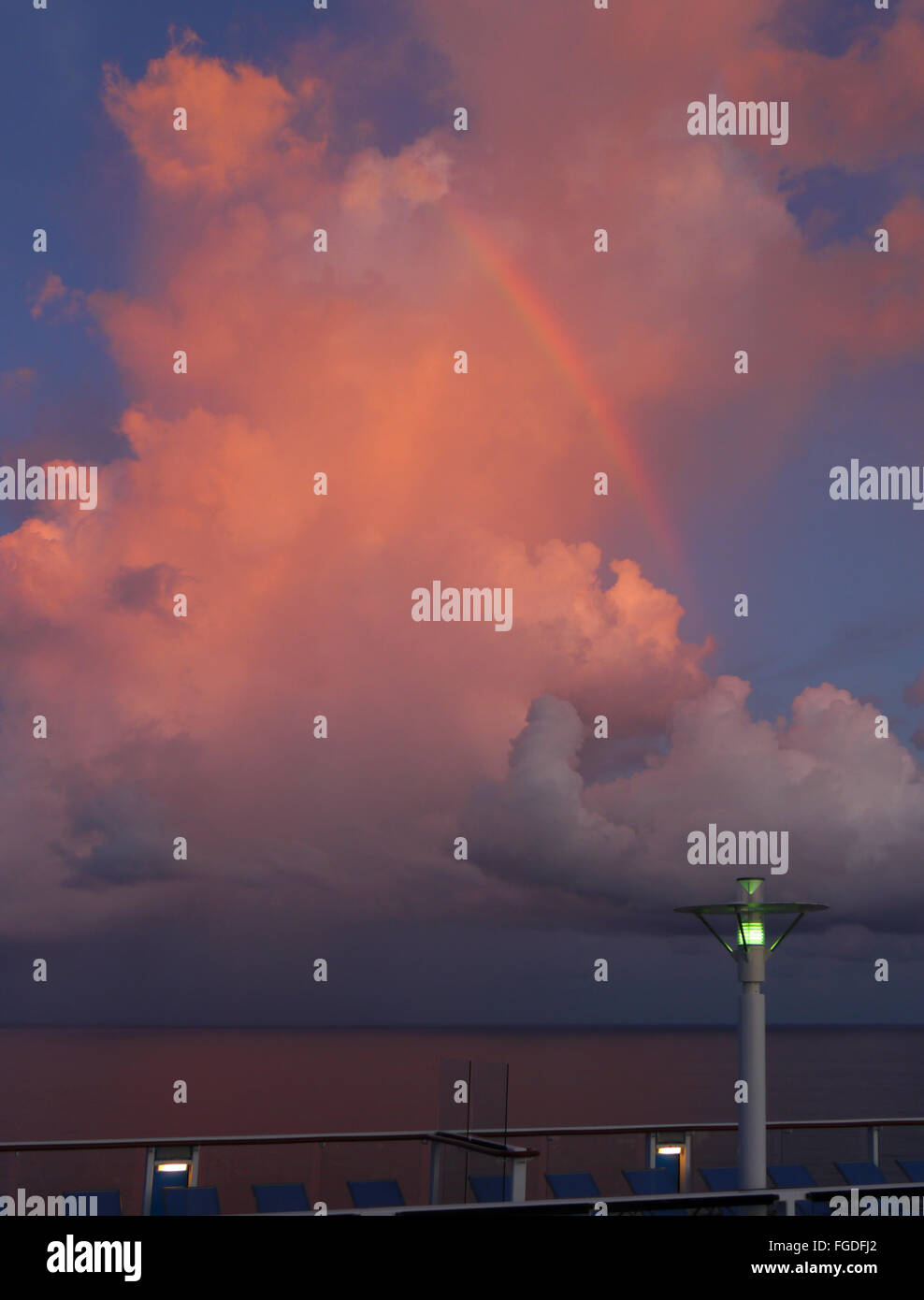 Pink cloud and a rainbow taken from Royal Caribbean's Quantum of the Seas cruise ship, South China Sea Stock Photo