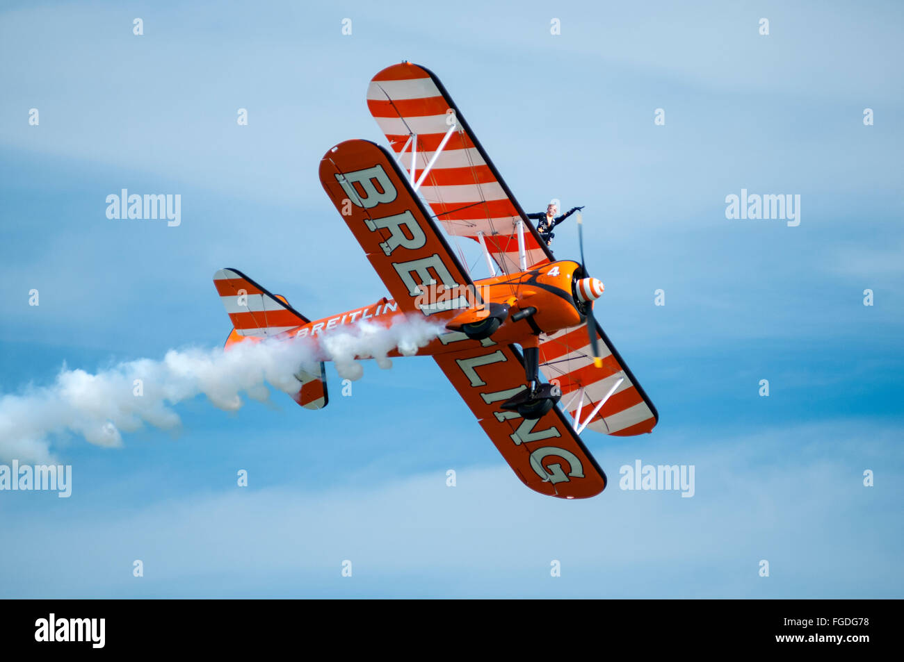 A display of 'wing walking' upon the wing of a Boeing Stearman aircraft during an air show. Stock Photo