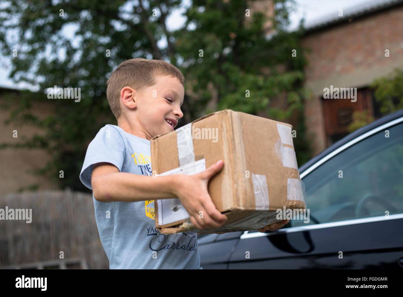 Boy carrying box hi-res stock photography and images - Alamy