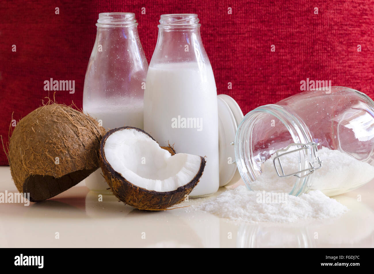 Coconut products. Cracked open coconut with meat cut in half, grounded