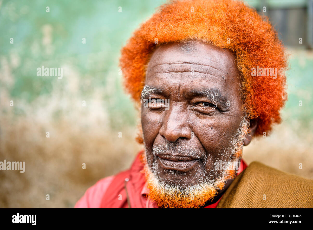 Portrait Of A Man With Curly Hair And Beard Dyed To Red Color
