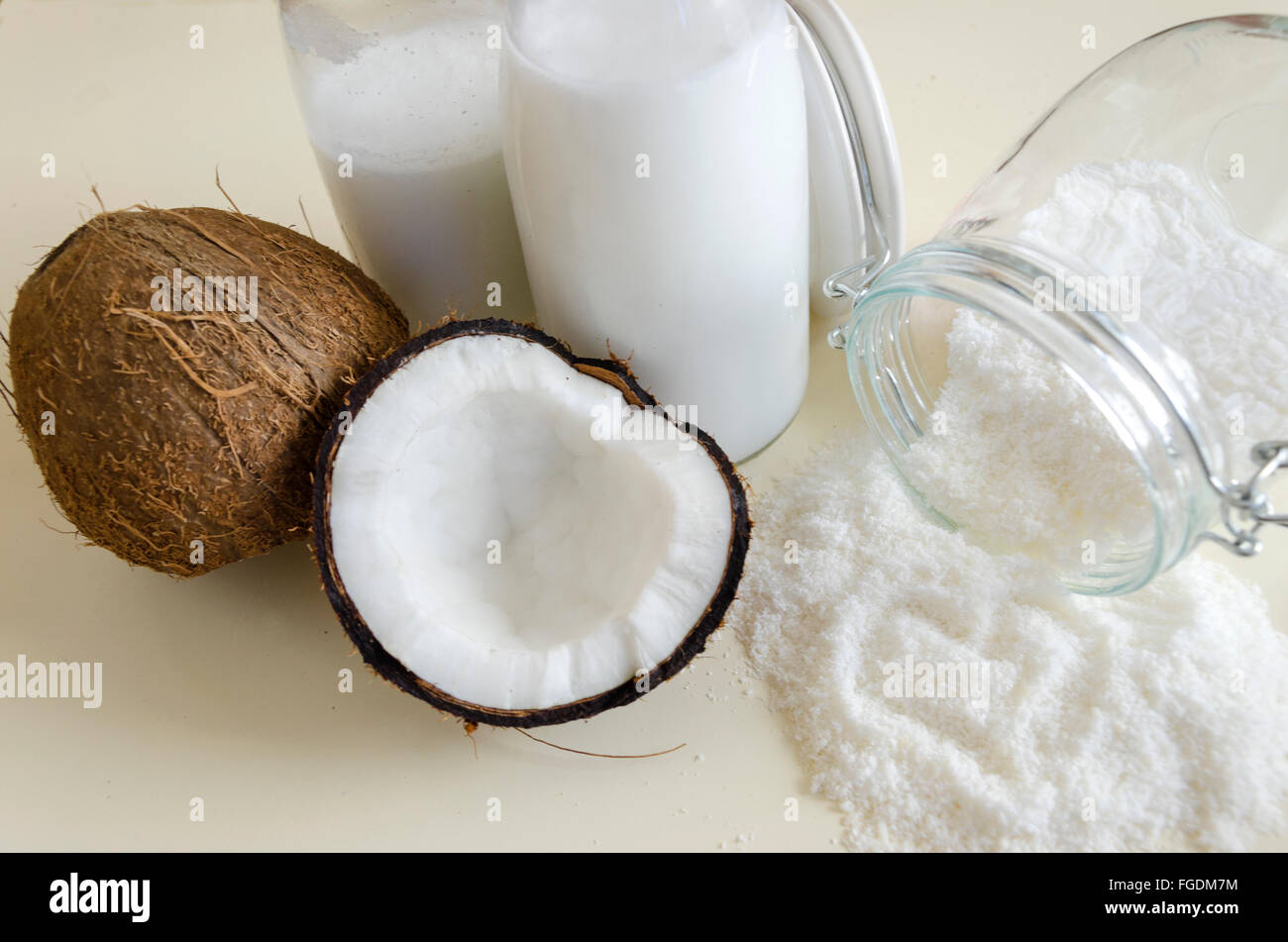 Coconut products. Cracked open coconut with meat cut in half, grounded