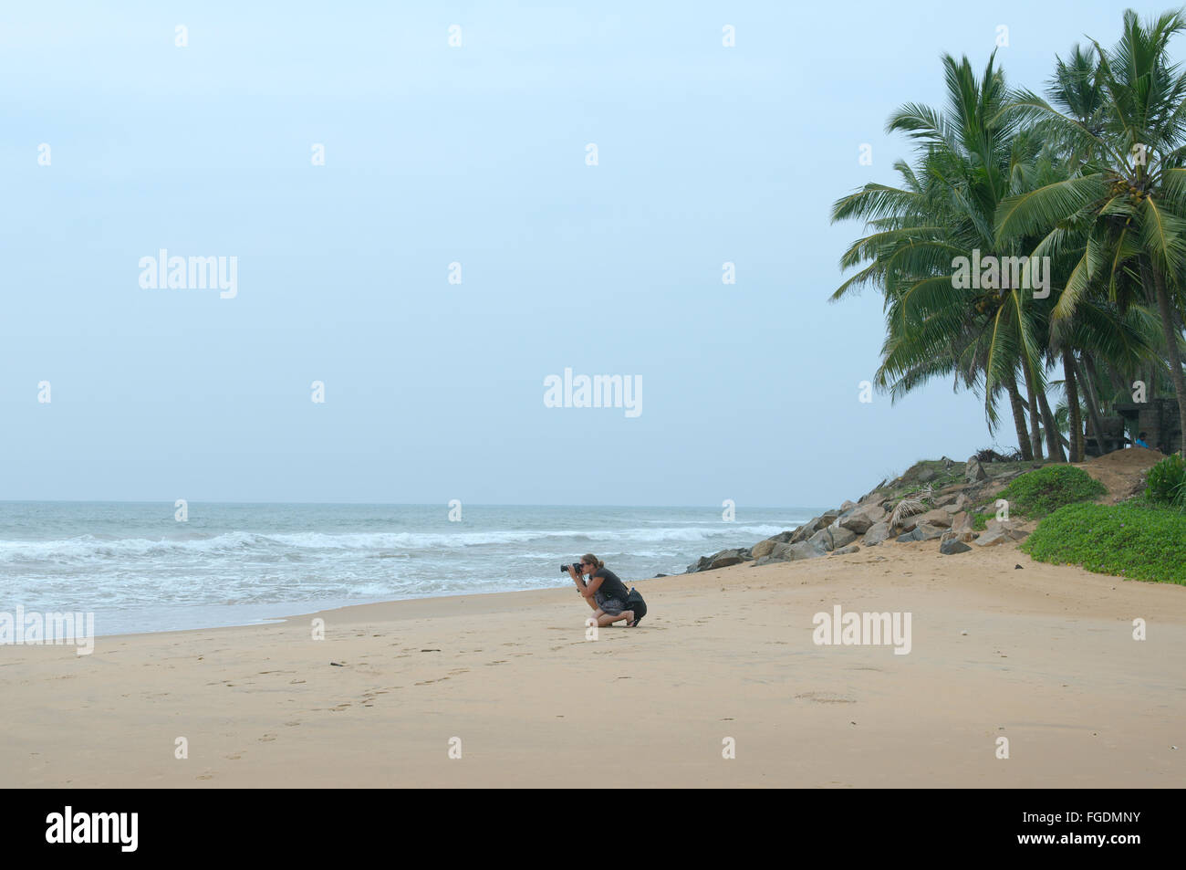 Young woman photographed the waves on the sandy beach, Hikkaduwa, Sri Lanka, South Asia Stock Photo