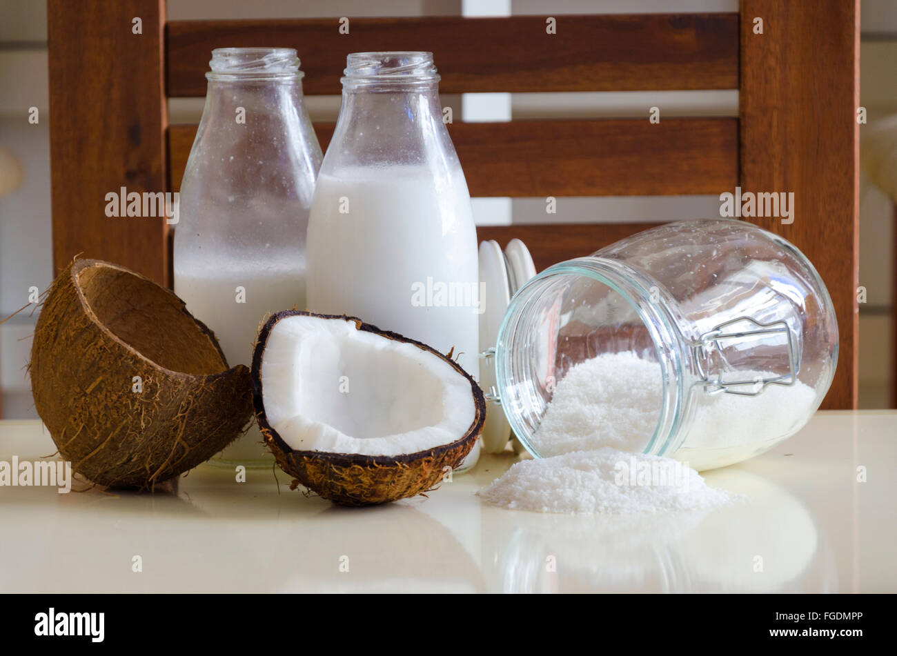 Coconut products. Cracked open coconut with meat cut in half, grounded