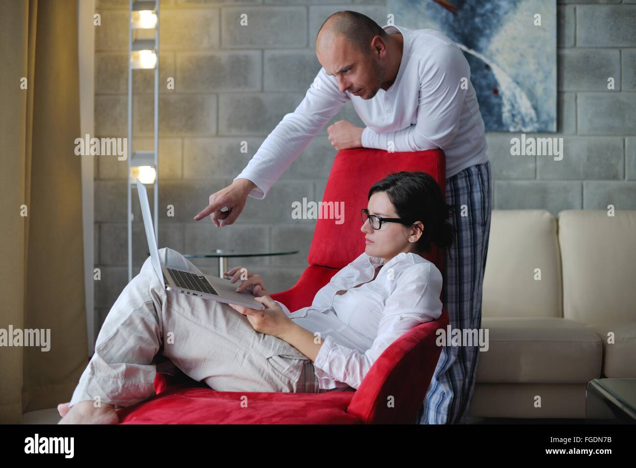 young couple using Laptop computer at home Stock Photo - Alamy