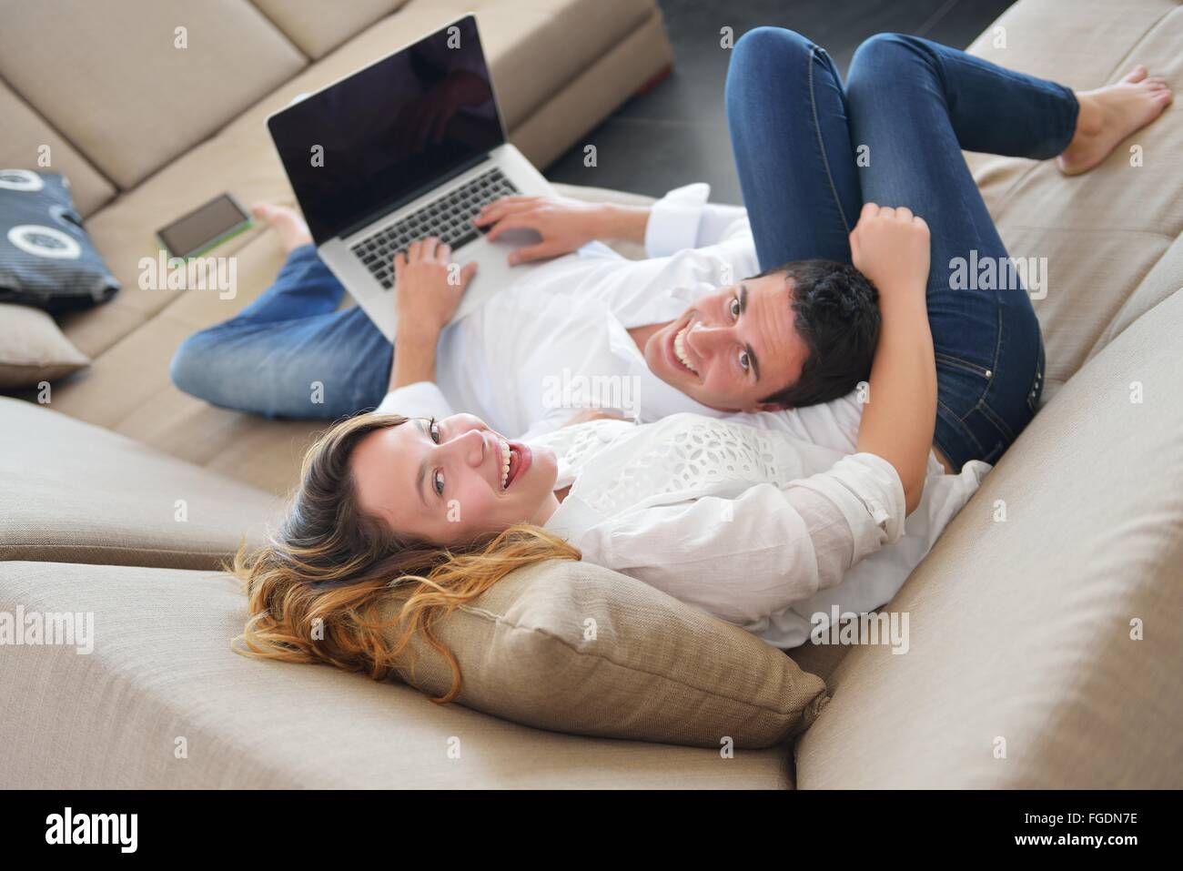 young couple using laptop at home Stock Photo