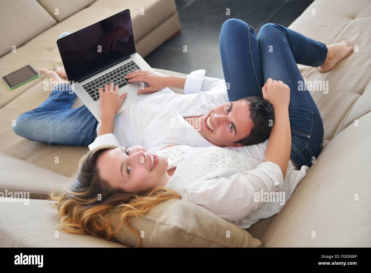 young couple using laptop at home Stock Photo - Alamy