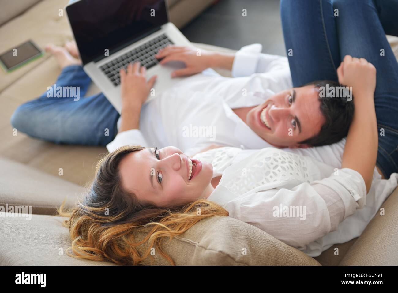 young couple using laptop at home Stock Photo - Alamy