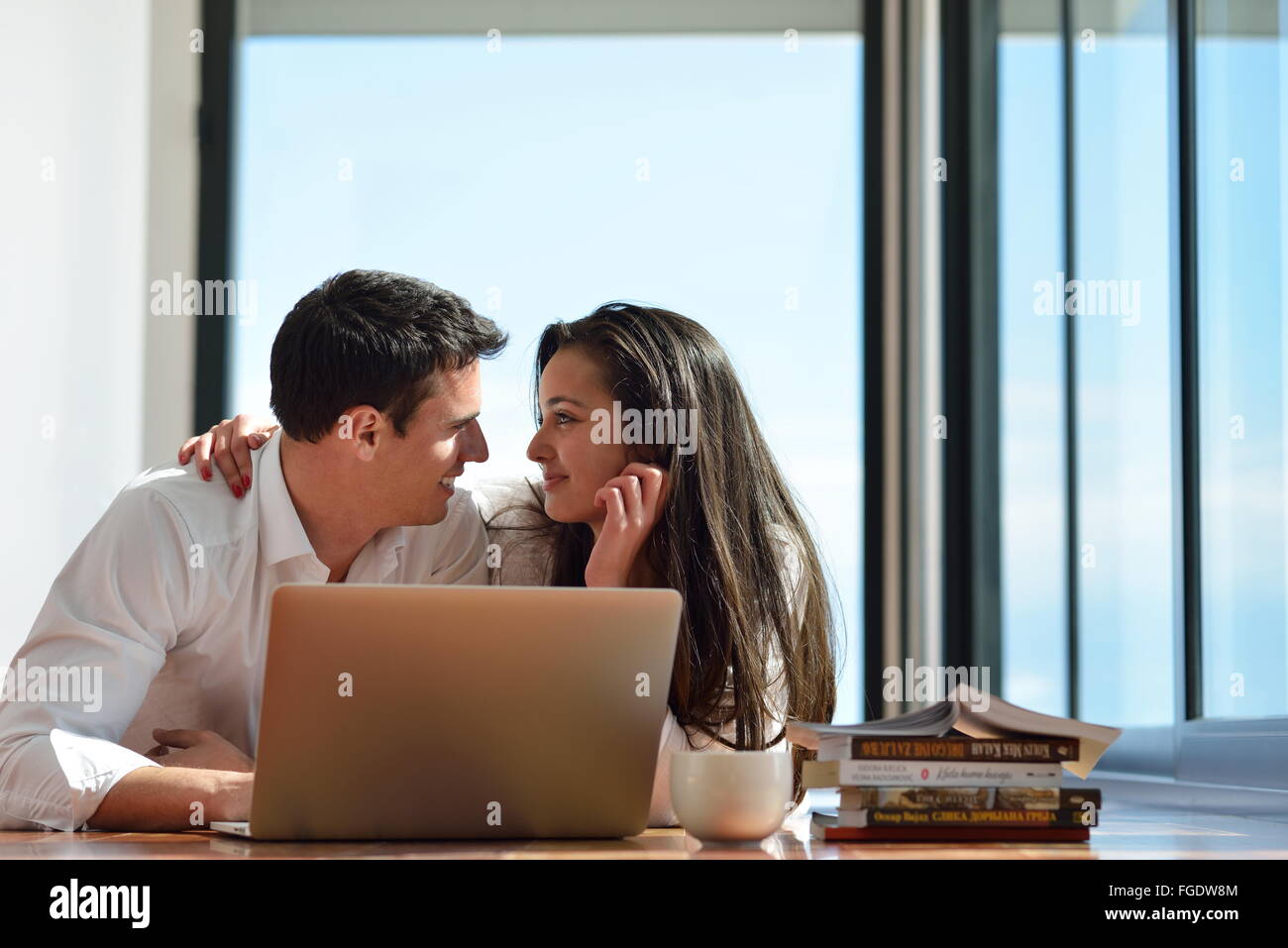 relaxed young couple working on laptop computer at home Stock Photo - Alamy