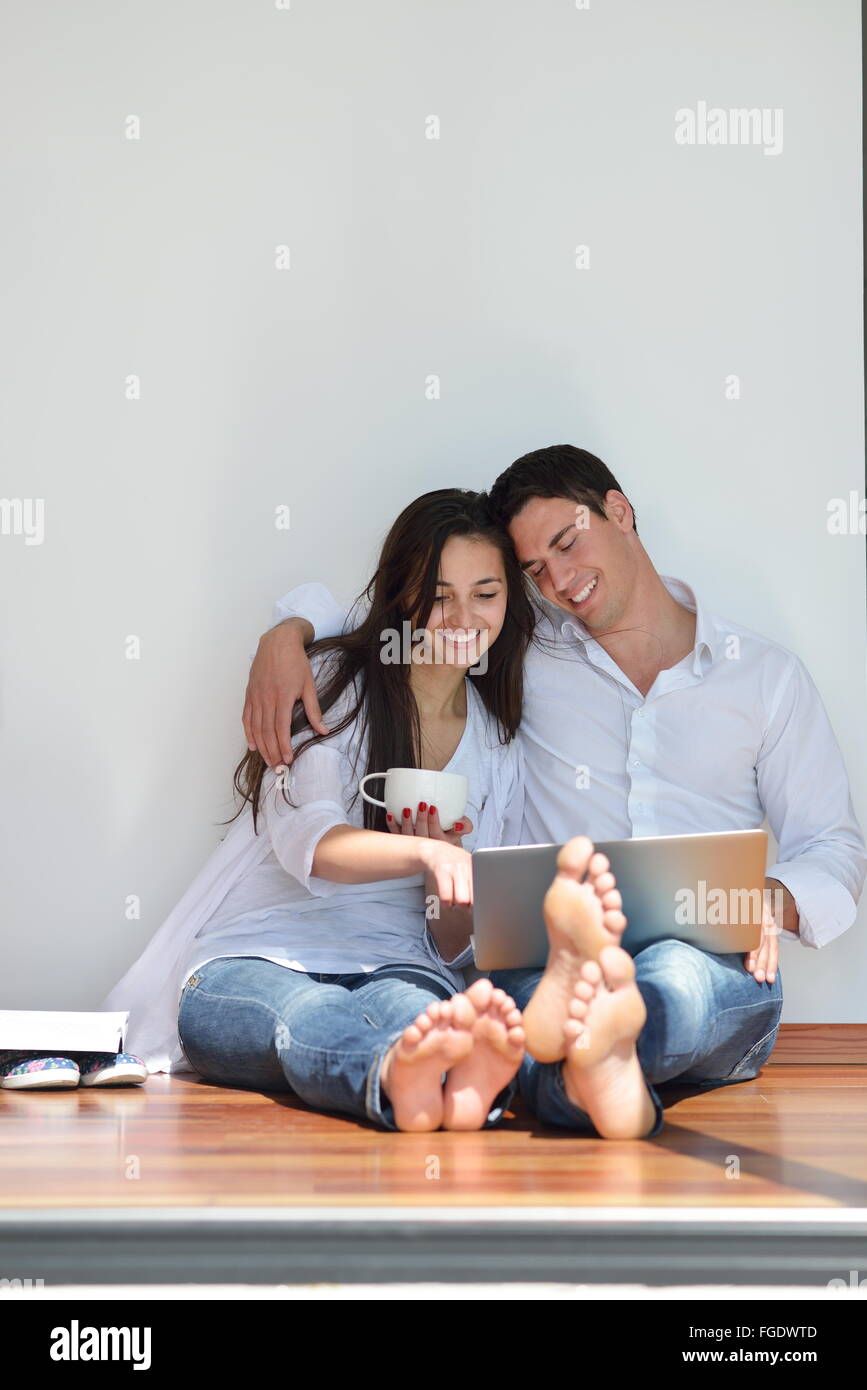 relaxed young couple working on laptop computer at home Stock Photo - Alamy