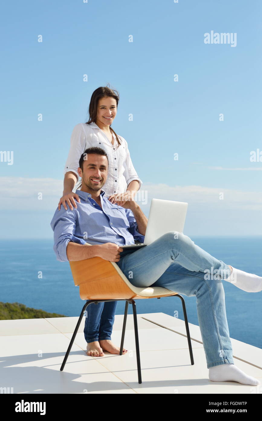 relaxed young couple working on laptop computer at home Stock Photo - Alamy