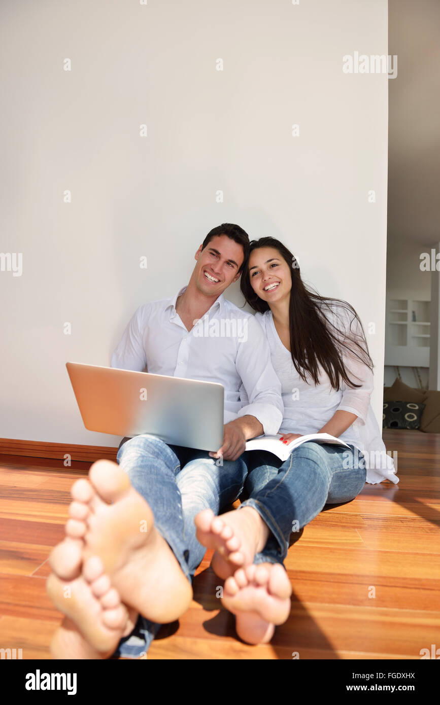 relaxed young couple working on laptop computer at home Stock Photo - Alamy