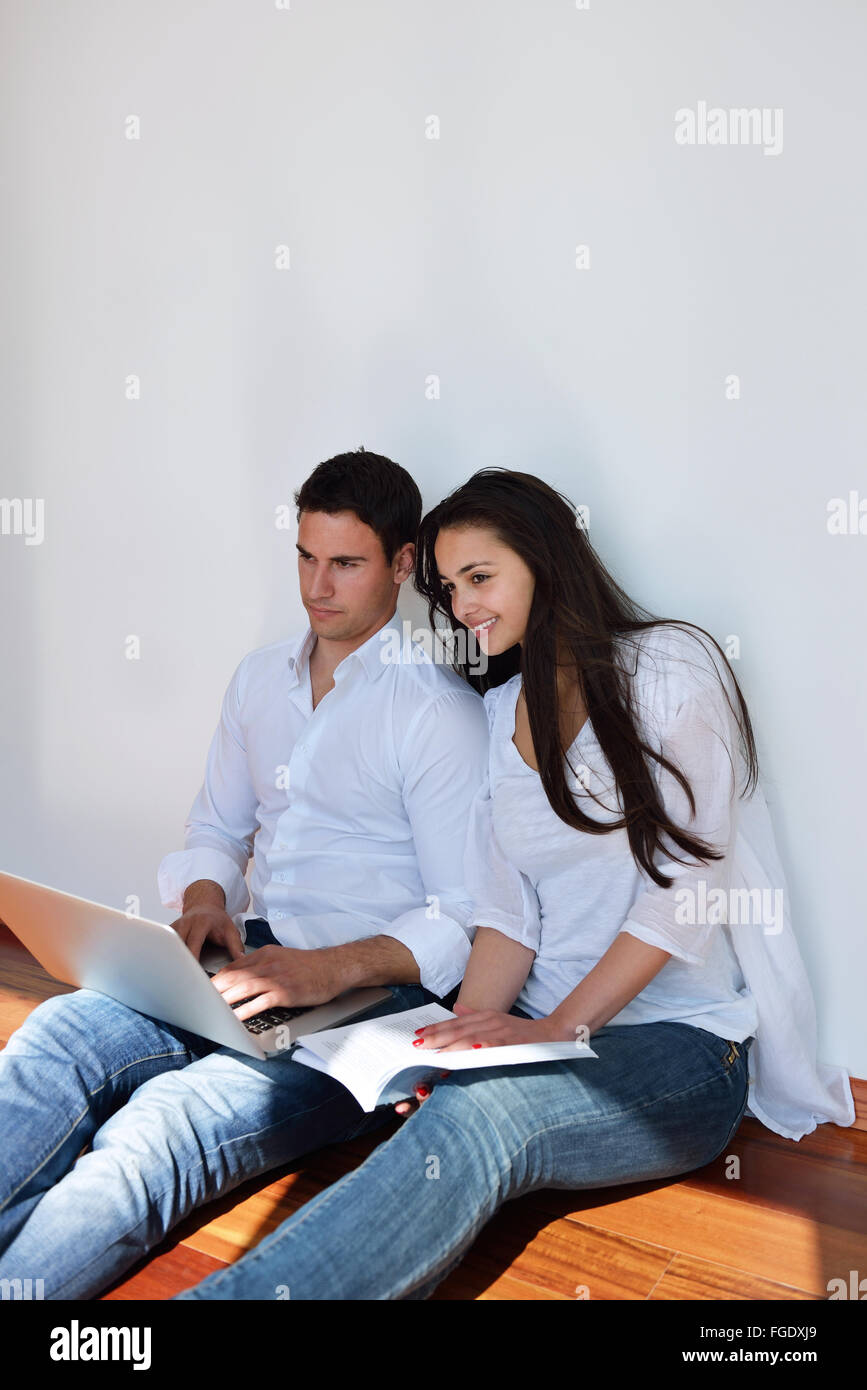 relaxed young couple working on laptop computer at home Stock Photo - Alamy