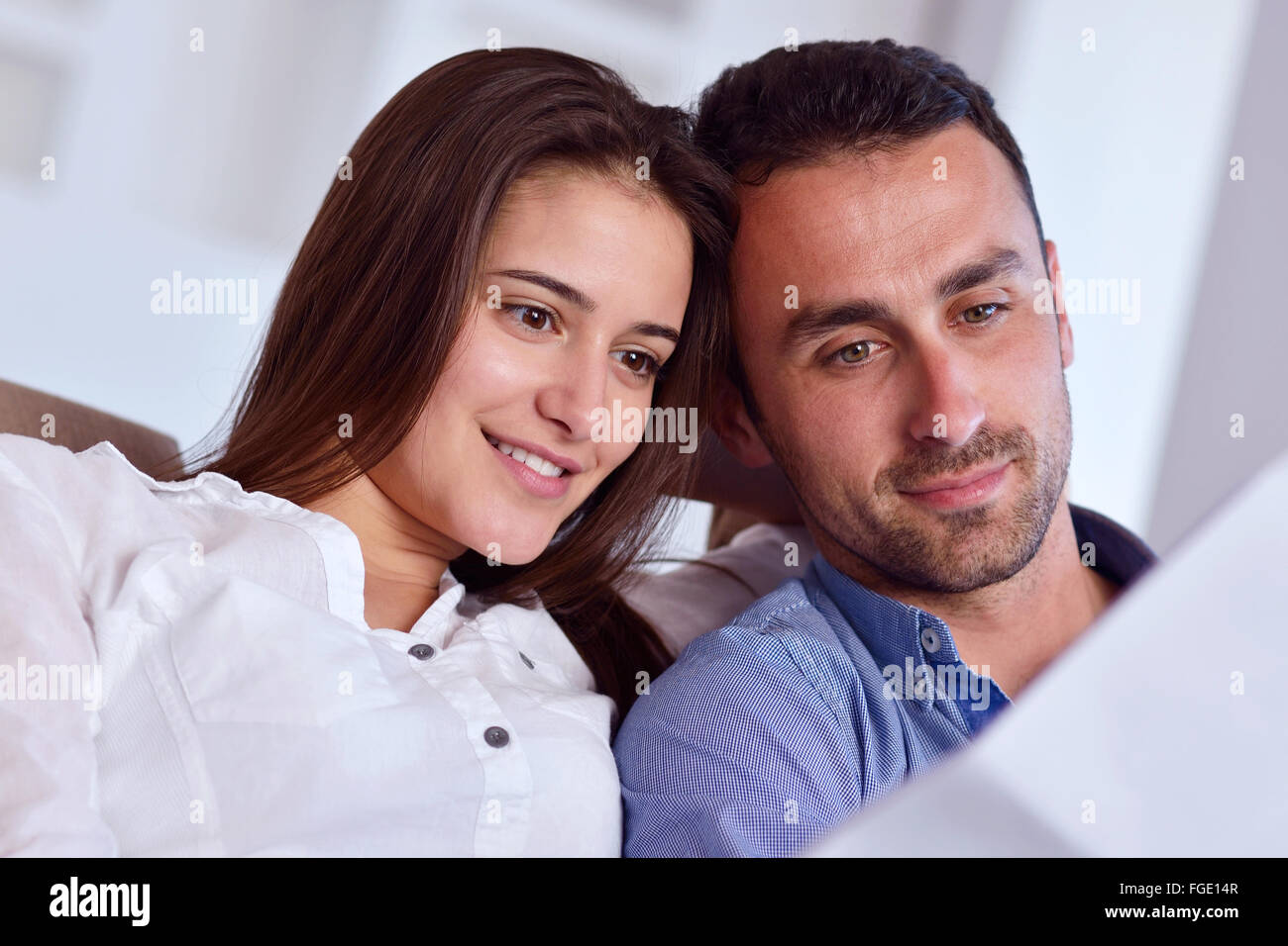 relaxed young couple working on laptop computer at home Stock Photo