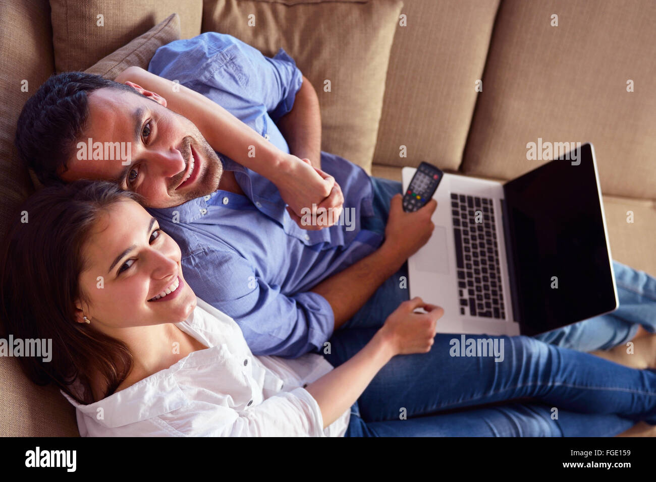 relaxed young couple working on laptop computer at home Stock Photo - Alamy