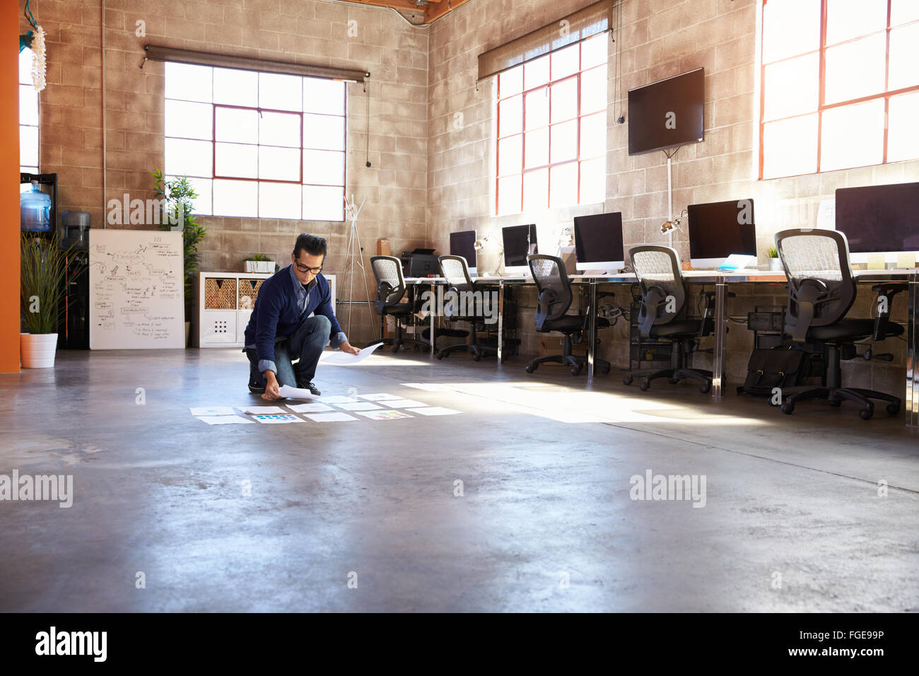 Designer Planning Layout On Floor Of Modern Office Stock Photo