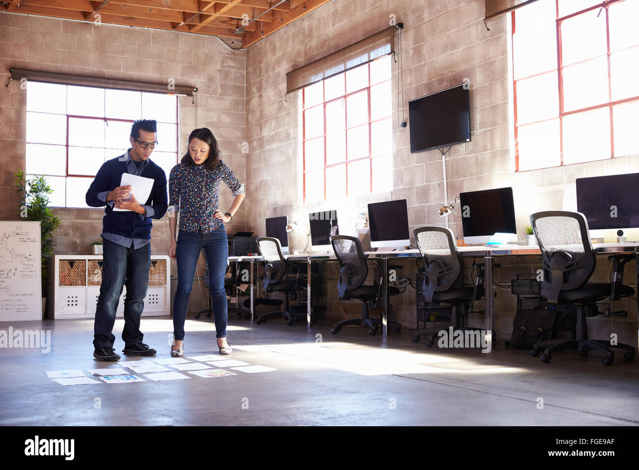Designers Planning Layout On Floor Of Modern Office Stock Photo