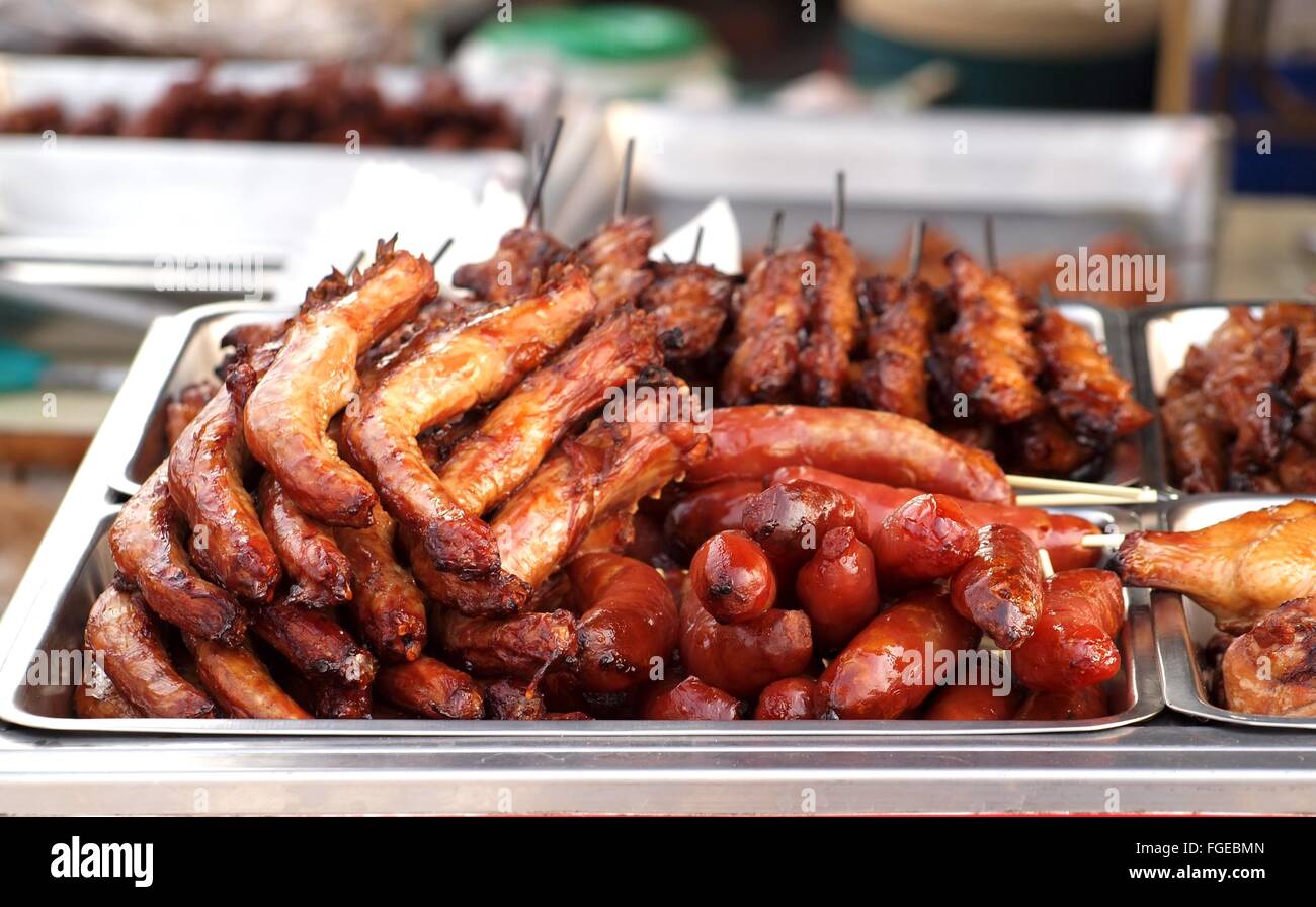 Grilled chicken necks, skewers and sausages for sale at an outdoor event  Stock Photo - Alamy