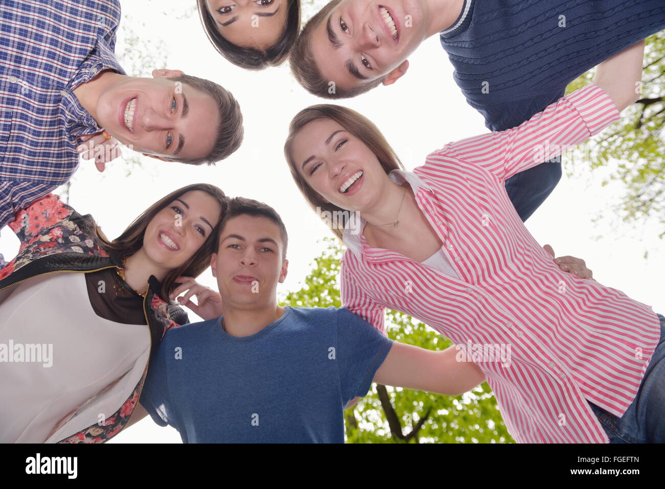 young friends staying together outdoor in the park Stock Photo