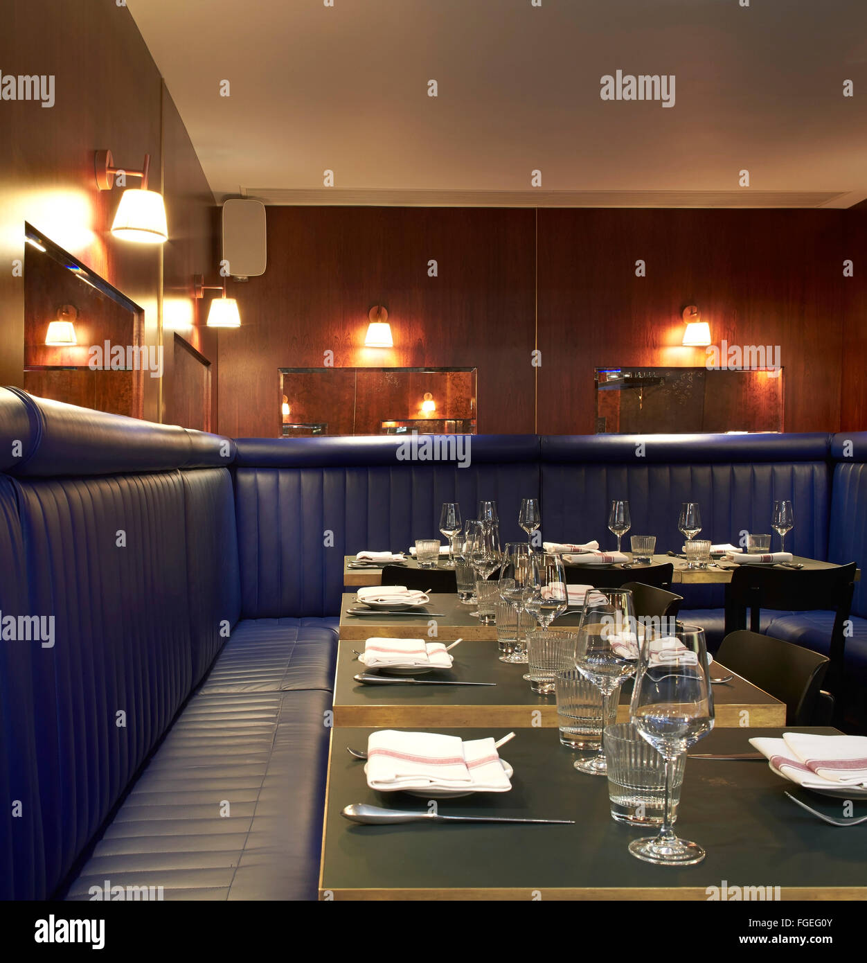 Dining room with upholstered bench seating. The Palomar Restaurant, London, United Kingdom. Architect: Gundry & Ducker, 2014. Stock Photo