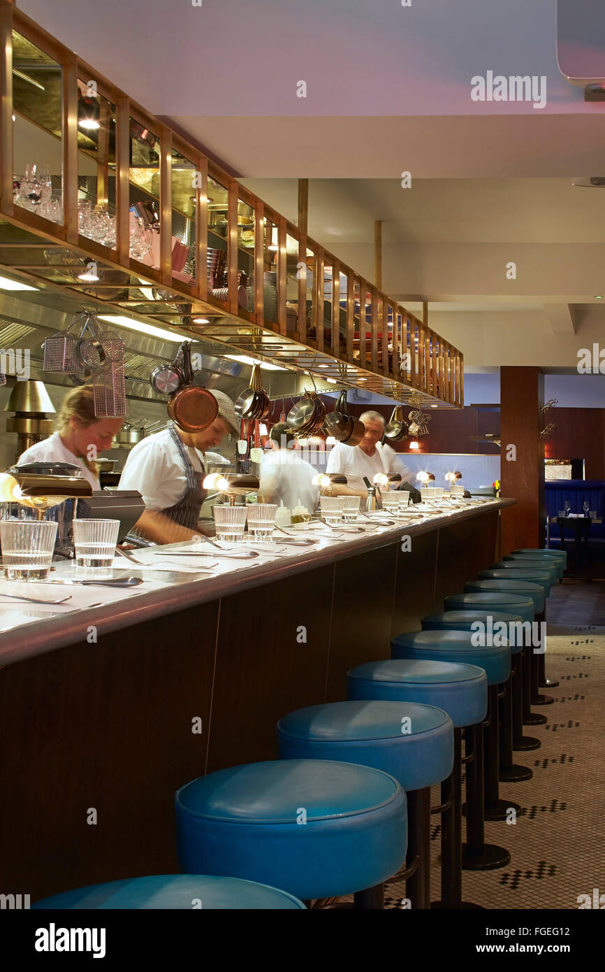 Open kitchen with bar counter seating and chefs at work. The Palomar  Restaurant, London, United Kingdom. Architect: Gundry & Duc Stock Photo -  Alamy