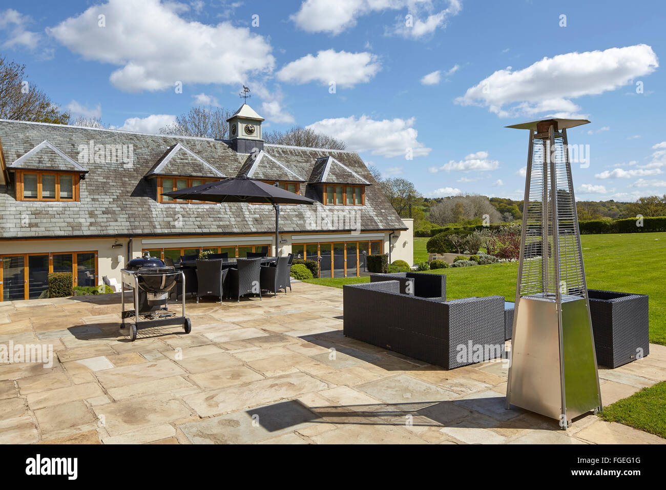 Exterior view with patio + seating, outdoor heater and barbecue in