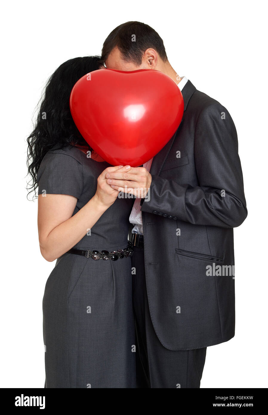 Couple kissing behind heart shaped hi-res stock photography and images ...
