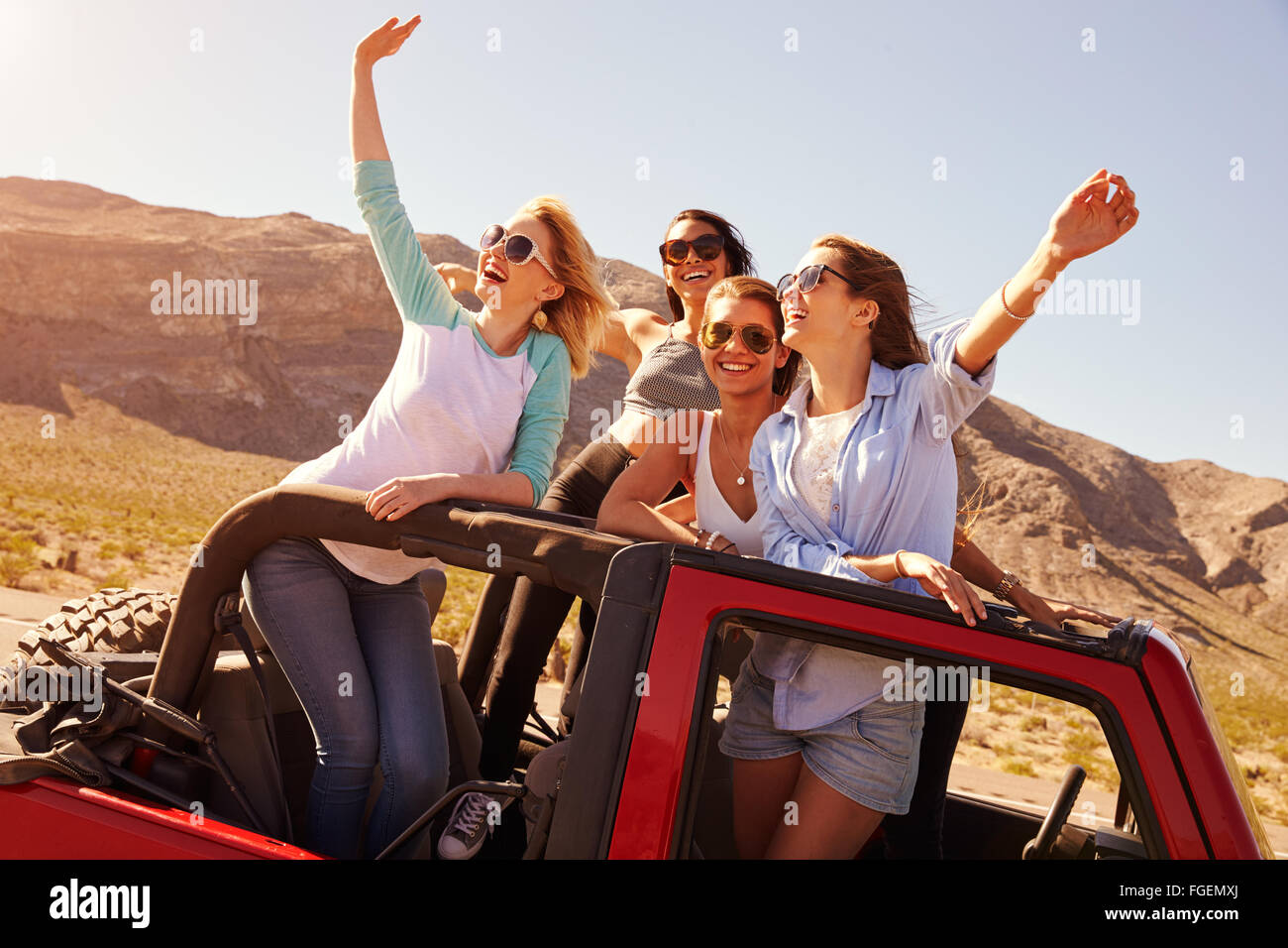 Four friends on the road in open car hi-res stock photography and ...