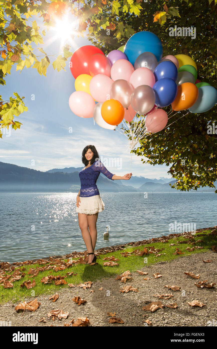 Young woman in blue top and white short skirt posi Stock Photo