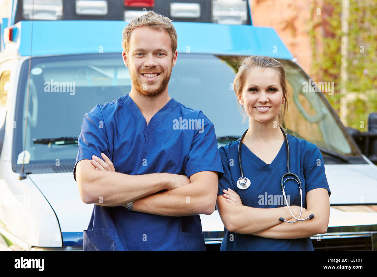 Portrait Of Medical Staff Standing In Front Of Ambulance Stock Photo