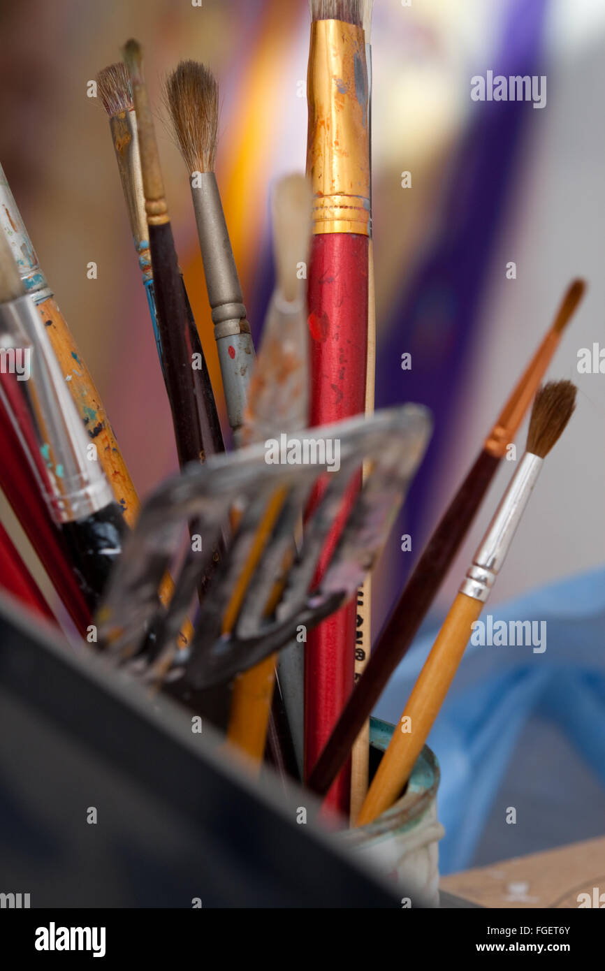 Artists brushes and paint container Stock Photo Alamy