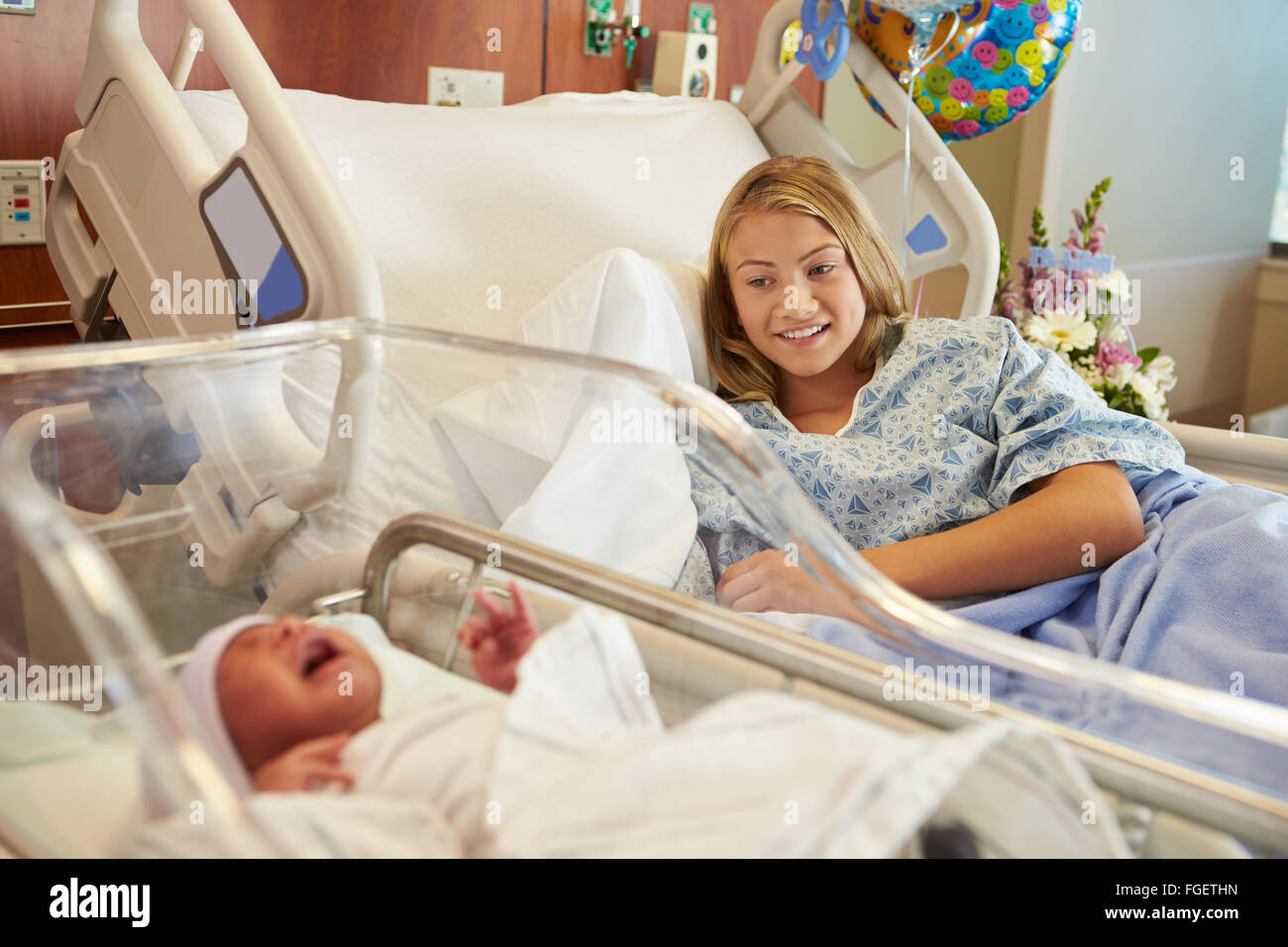 Teenage Girl With Newborn Baby Son In Hospital Stock Photo
