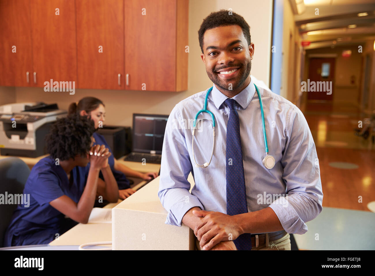 Portrait Of Male Doctor At Nurse's Station In Hospital Stock Photo - Alamy