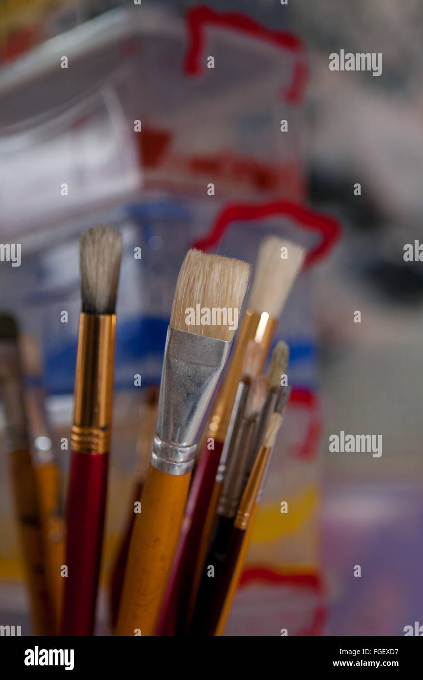 Artists brushes and paint container Stock Photo Alamy