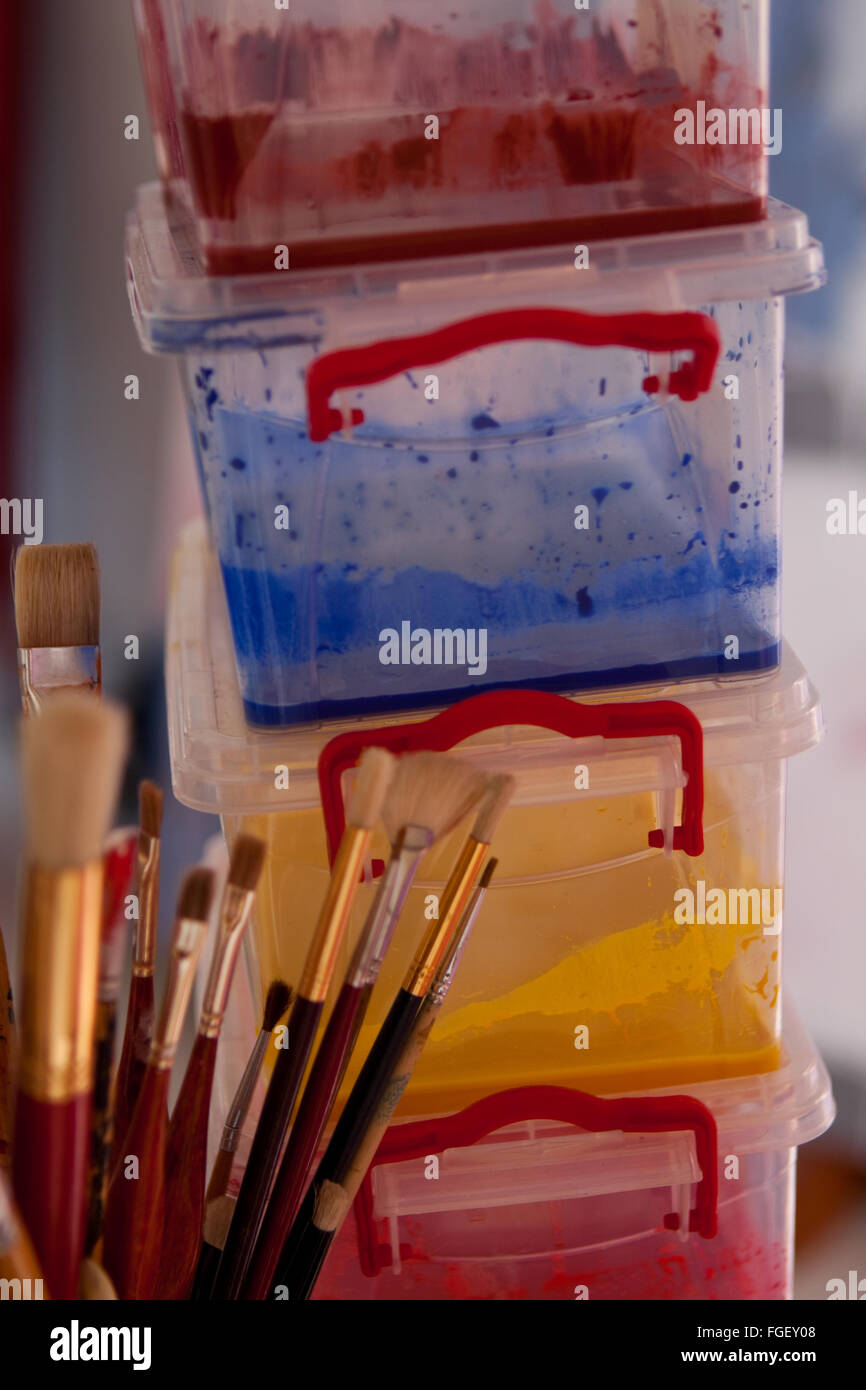 Artists brushes and paint container Stock Photo Alamy