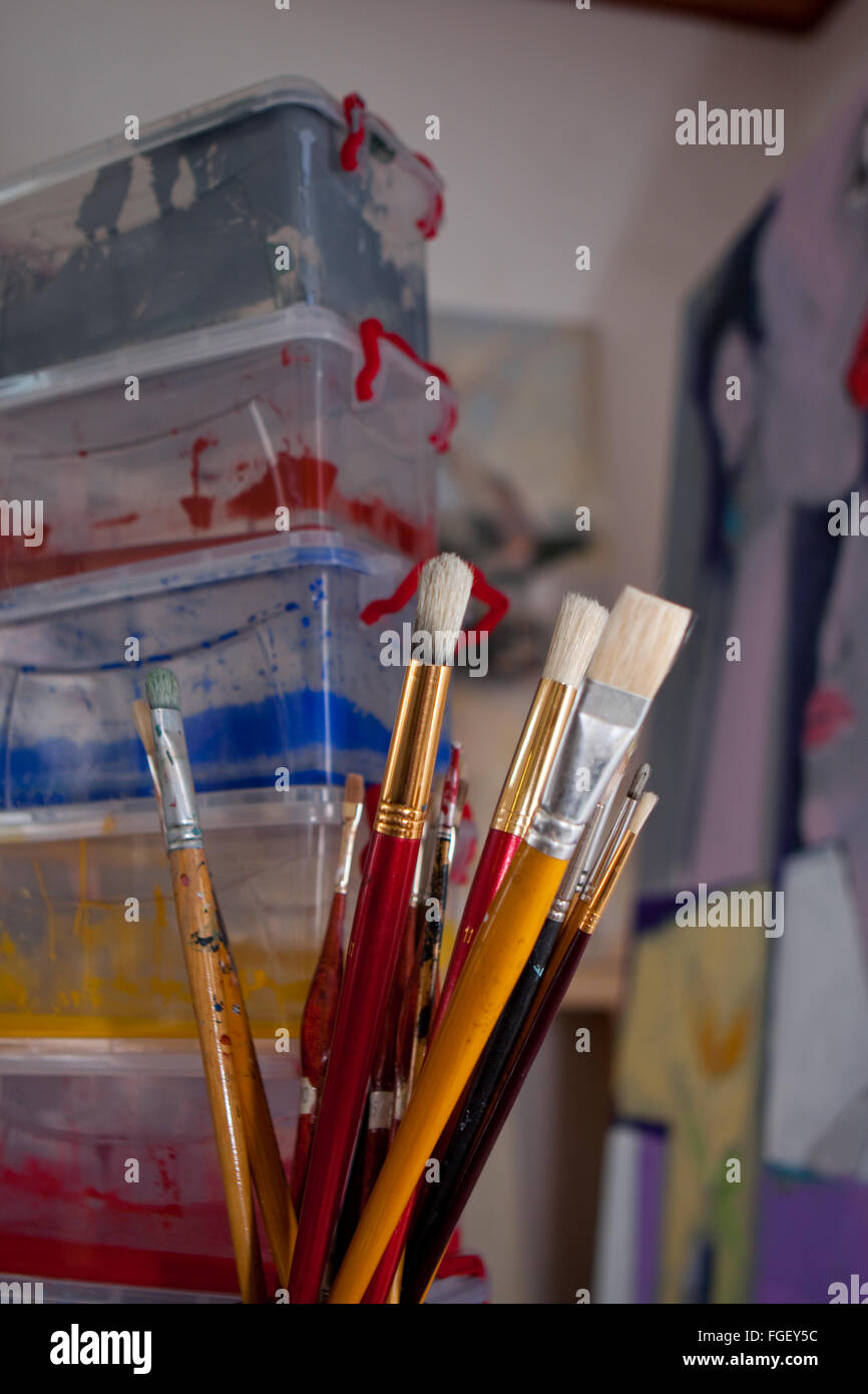 Artists brushes and paint container Stock Photo Alamy