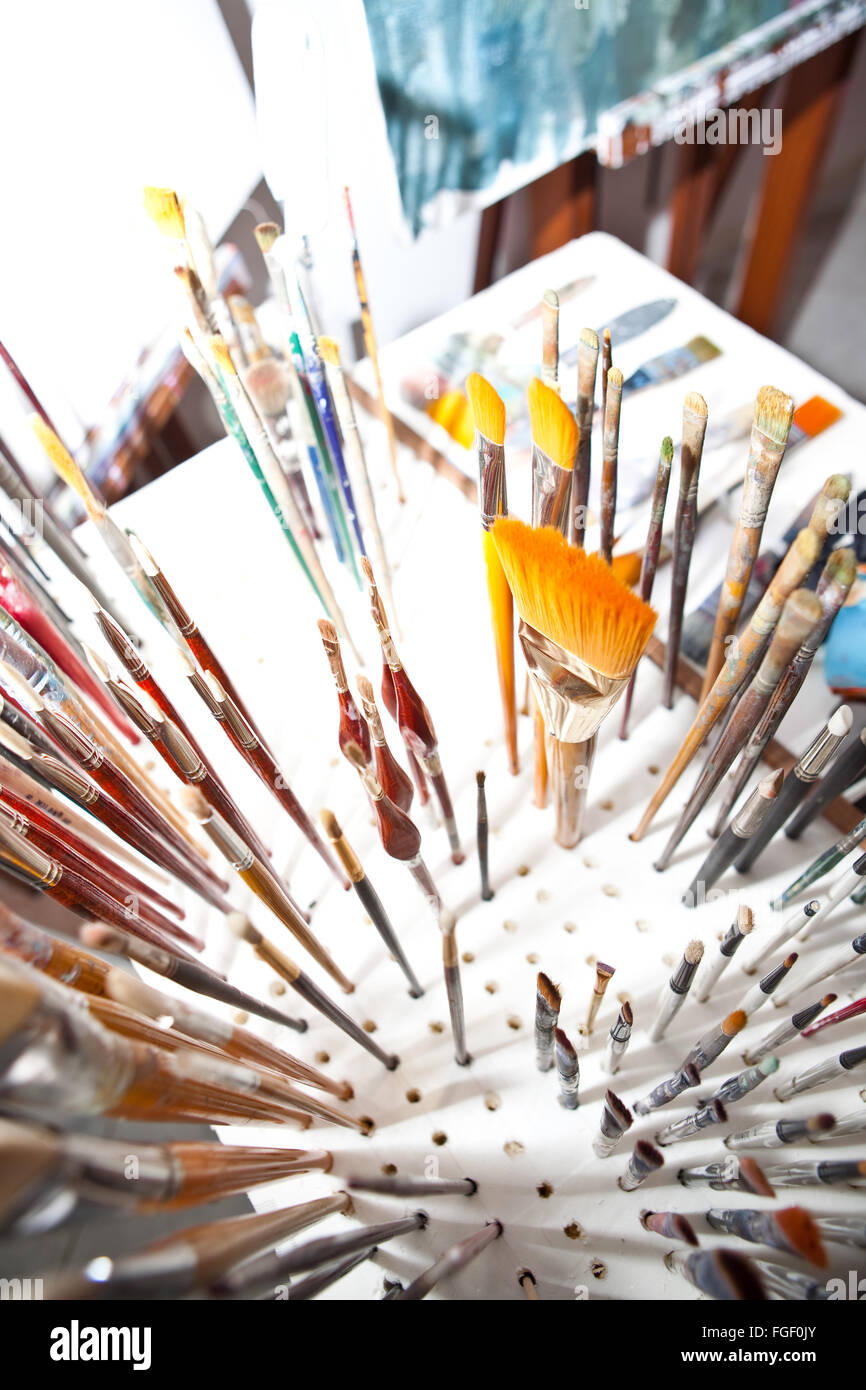 Artists brushes and paint container Stock Photo Alamy